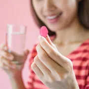 A female having Lovegra 100 Mg with water.