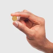 A hand holding Vilitra 20 mg tablet.