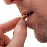A man taking Vilitra 20 Mg tablet.
